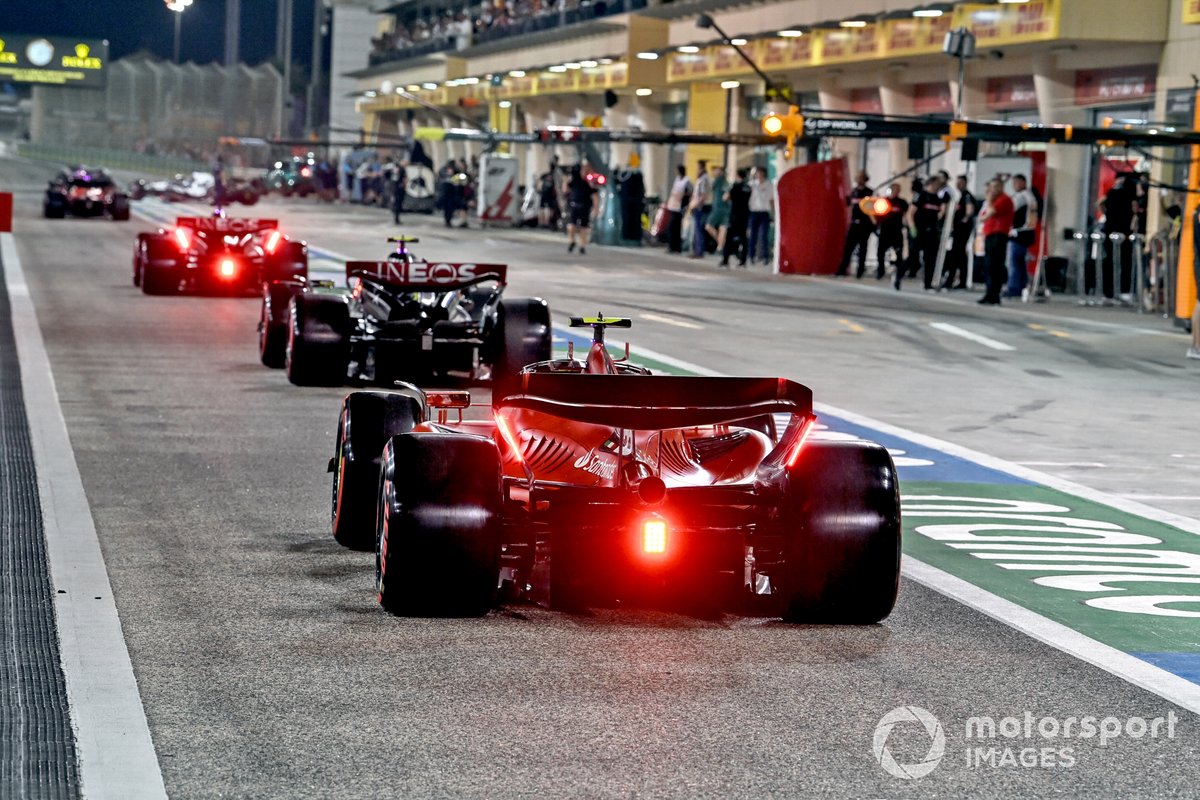 Lewis Hamilton, Mercedes F1 W14, Carlos Sainz, Ferrari SF-23, in the pit lane