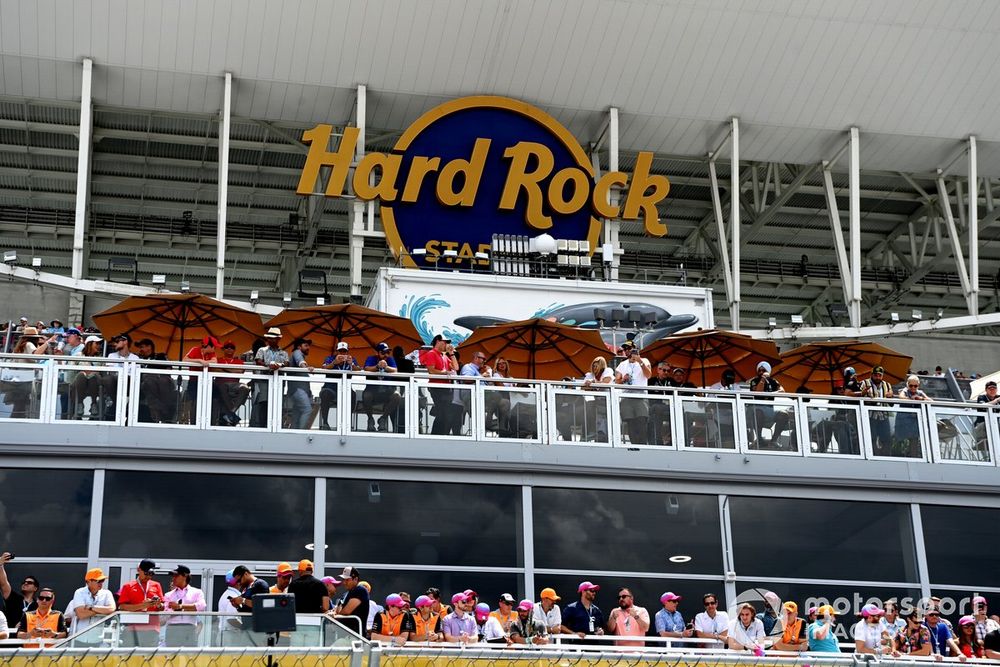 Fans watch under the Hard Rock Stadium cover