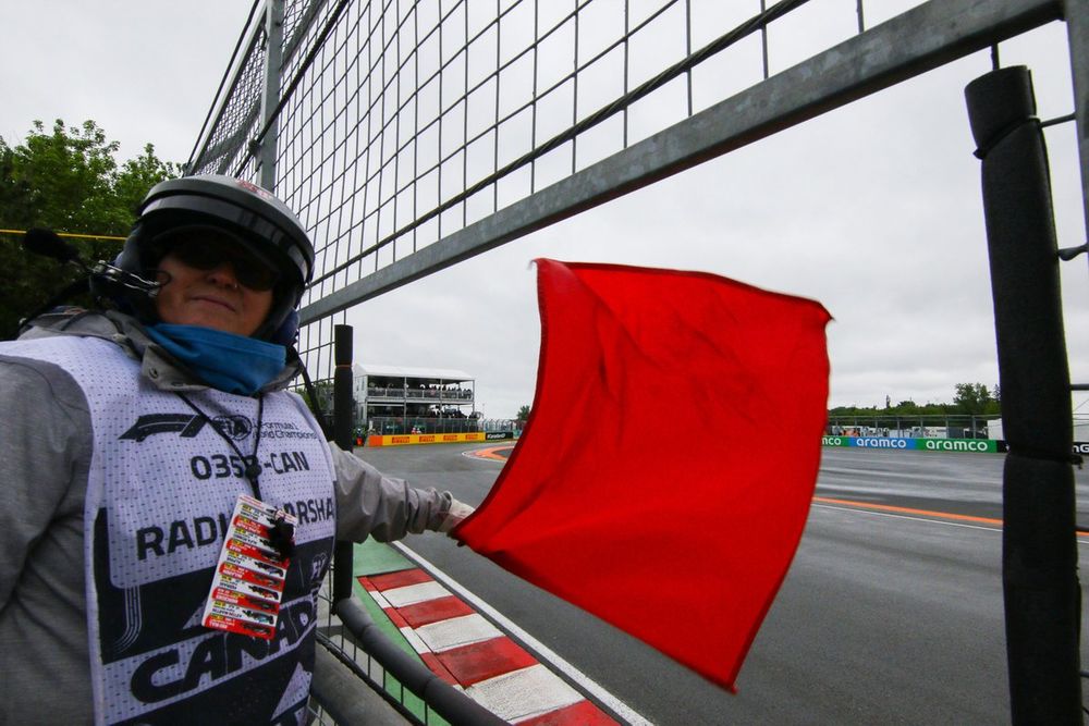 A marshal waves the red flag